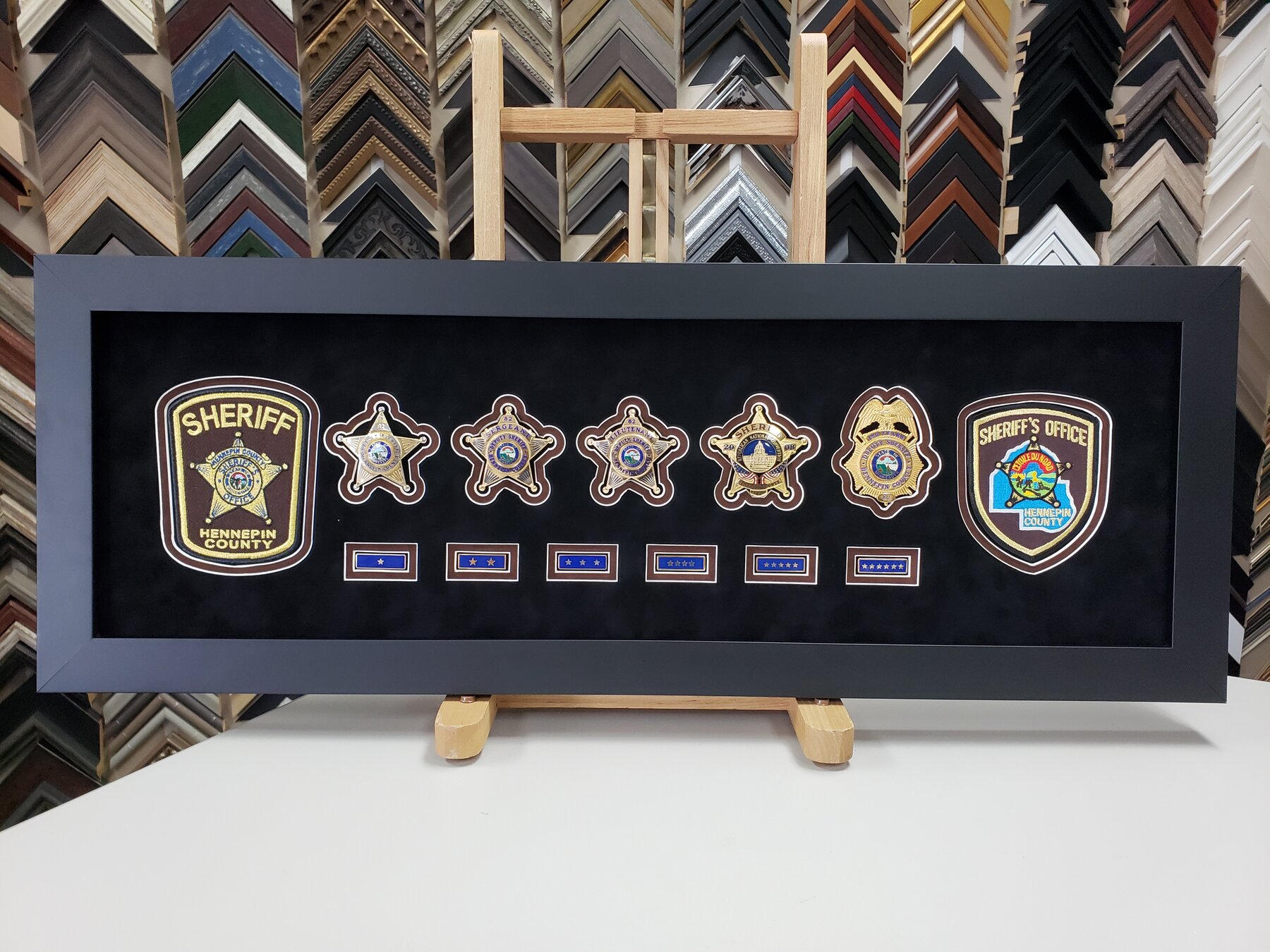 Full project view of sheriff’s office career badge display custom framing project