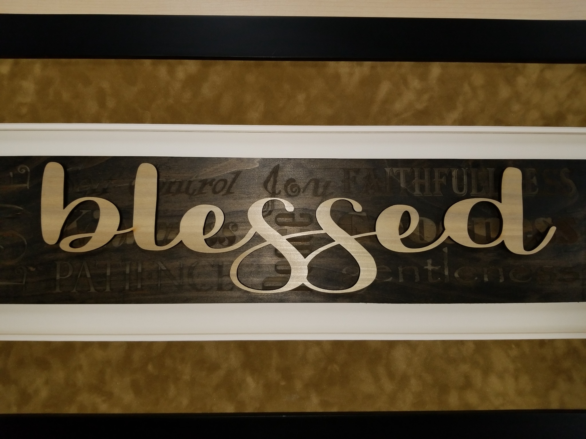 Full view of a layered blessed wood display with laser-cut lettering and engraved background